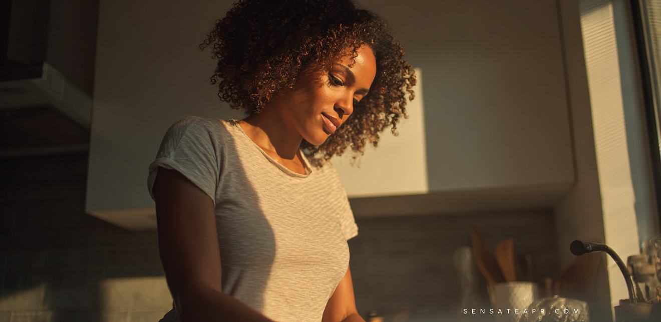 Person humming while doing chores to activate the vagus nerve via vocal vibration